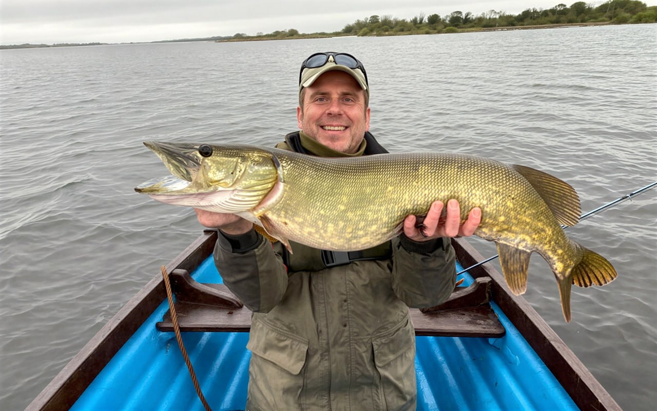 J R Bartley holding a pike